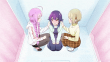 a girl with purple hair sits between two girls