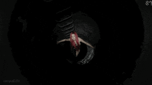 a woman with red hair is wearing a black top