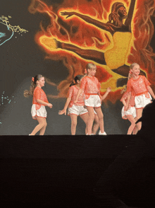 a group of young girls dancing on a stage