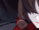 a close up of a girl 's face with brown hair and a red sweater .