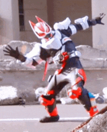 a person in a superhero costume is standing on a rock