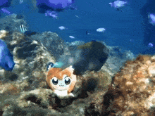 a stuffed animal that looks like a hamster swimming in the ocean
