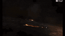 a large explosion in the dark with a lot of fire coming out of it .
