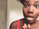 a close up of a woman 's face with a surprised expression