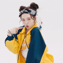 a woman wearing a bandana and a yellow jacket with the letter ef on it