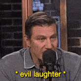 a man speaking into a microphone with the words " evil laughter " below him