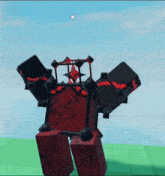 a red and black block with spikes on it is laying on a green field