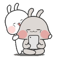 a couple of rabbits are hugging each other and one is holding a cell phone .