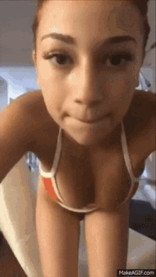 a woman in a bikini is making a funny face