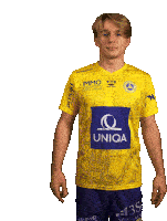 a young man is wearing a yellow shirt with immo united and uniqa on it