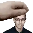 a man wearing glasses is being touched by a hand .