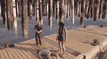 a man laying on a dock with a woman standing behind him