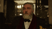 a man with a beard wearing a tuxedo and bow tie says " ok "