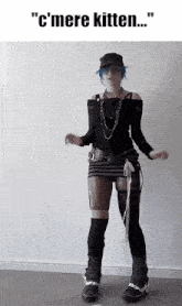 a woman with blue hair is dancing with the words " c'mere kitten " on the bottom