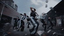 a group of people are dancing in front of a store that says loans on