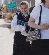 a woman wearing a jacket with the letter s on it smiles