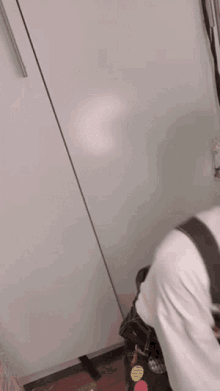 a blurry picture of a person standing in front of a wall .