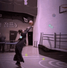 a person playing basketball in front of a wall with korean writing on it
