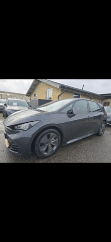 a grey car is parked in front of a house