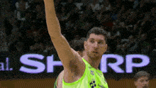 a basketball player in a green jersey with the word sharp on it
