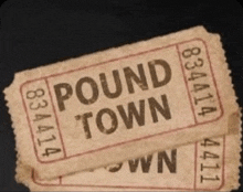 a ticket for pound town is stacked on top of another ticket