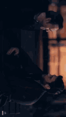 a man and woman kissing in a dark room