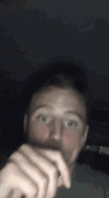 a close up of a man 's face with his mouth open