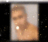 a blurred image of a man with a beard is surrounded by stars