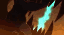a close up of a dragon 's teeth with a blue light coming out of them