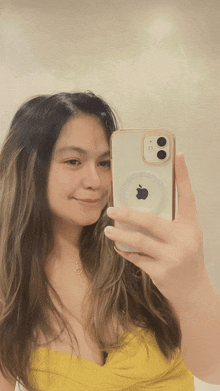 a woman is taking a selfie with her iphone