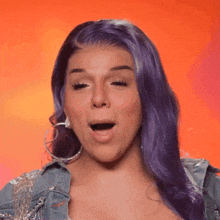 a woman with purple hair and hoop earrings is making a funny face