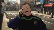 a police officer talking on a cell phone in front of a corner coffee shop