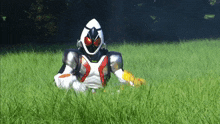 a man in a superhero costume is laying in a field of tall grass