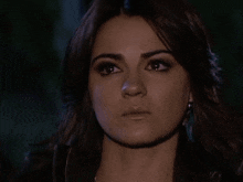 a close up of a woman 's face with dark hair