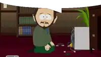 a man with a beard is kneeling down in front of a computer