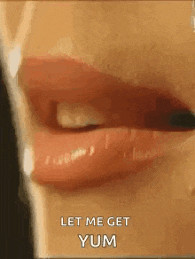 a close up of a woman 's mouth with red lipstick and the words `` let me get yum '' .