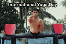 a shirtless man is doing a split in front of a sign that says " international yoga day "