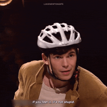 a man wearing a bicycle helmet says if you feel it it 's not stupid