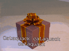 a gift box with a bow and the words " cataquack cataquack cataquack " written on it