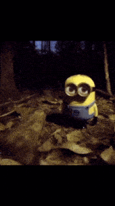 a yellow minion wearing boxing gloves is holding two red balls