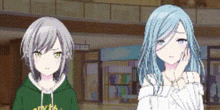 a couple of anime girls standing next to each other in a room .