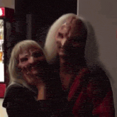 a man and a woman are posing for a picture and the woman is wearing a mask