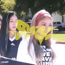 a girl wearing a pink headband and a black shirt that says i love you