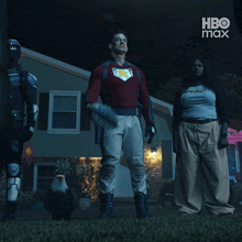 a group of people standing in front of a house with hbo max written on the bottom right