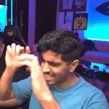 a man in a blue shirt with ronaldo 7 on his jersey