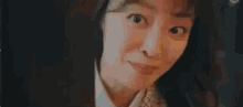 a close up of a woman making a funny face while looking at the camera .