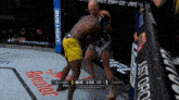two men are fighting in a boxing ring with a bud light banner