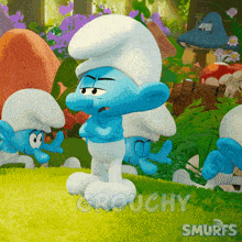 a group of smurfs are standing in a grassy area with the words grouchy smurfs written on the bottom