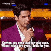 a man in a purple suit is holding a microphone and saying `` katrina , my eyes look for your eyes . ''