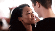 a man and a woman are looking at each other .
